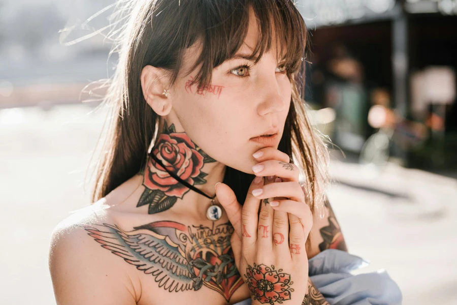 Tattooed Girl with Hands Clasped under Chin