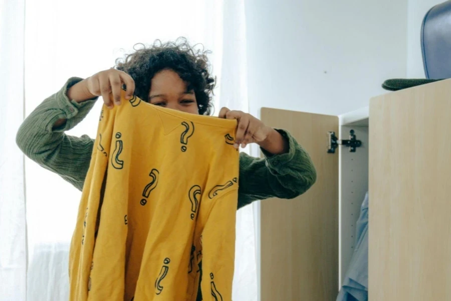 Teenager choosing clothes in bedroom