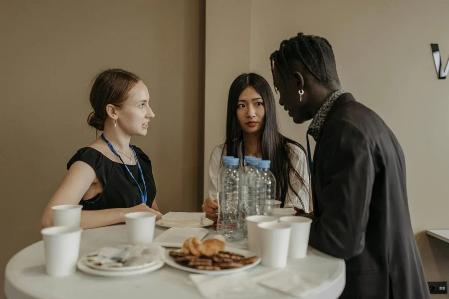 Three People Talking Near a Table