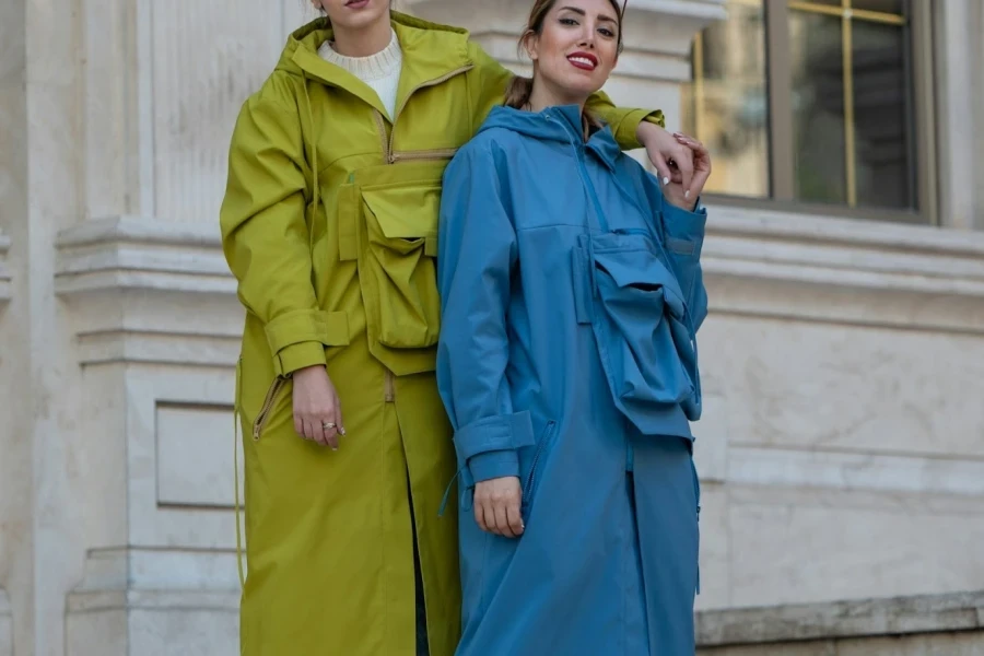 Two women wearing fashionable raincoats