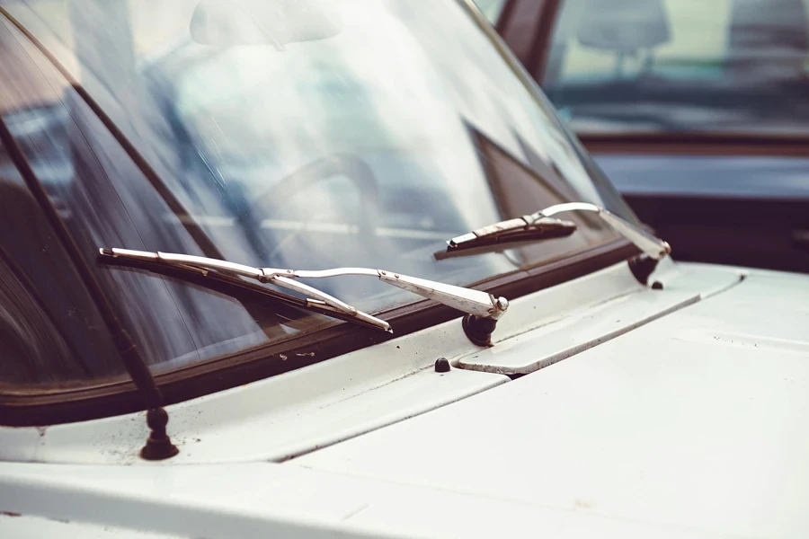 Wipers on the Windshield of White Car