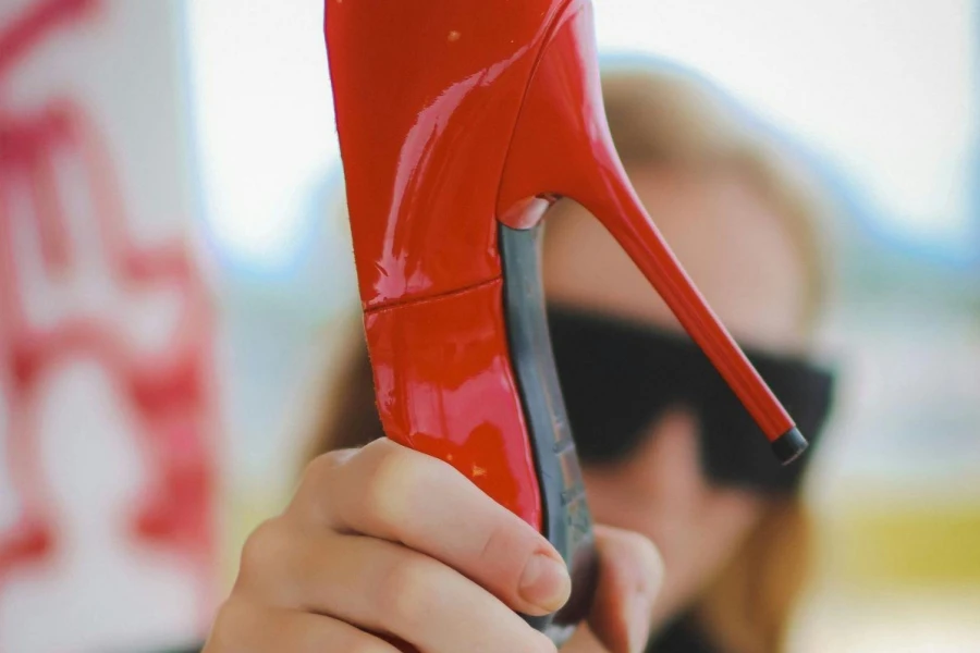 Woman Holding a Red High Heel in her Hand