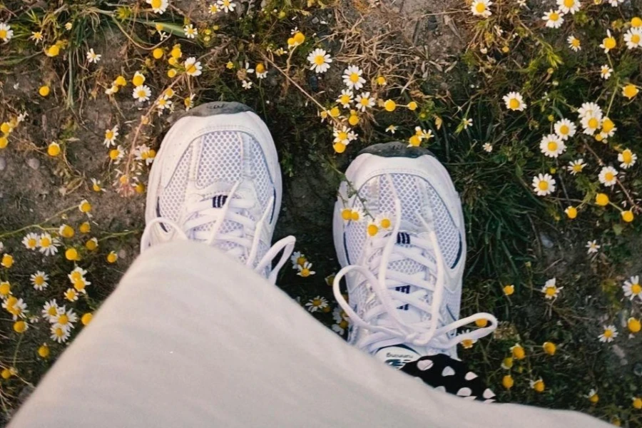 Woman Standing Among Chamomile Flowers