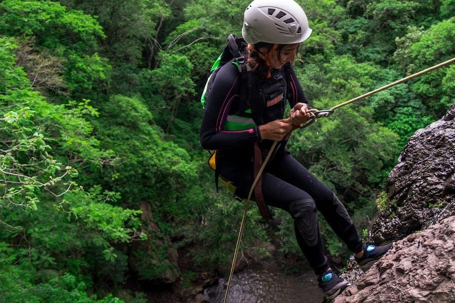 Woman climbing a mountain cliff