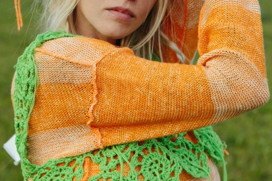 Woman in Orange Sweater and Green Crochet Top