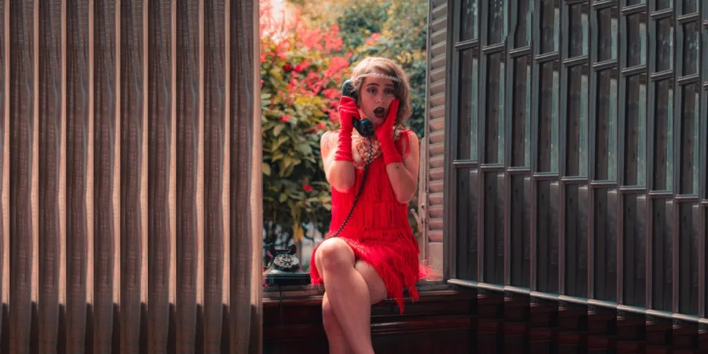 Woman in a red tasseled flapper dress with matching gloves