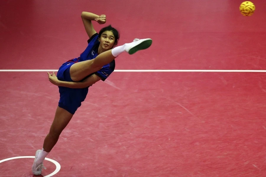 Woman in sepak takraw outfit in an athletic pose