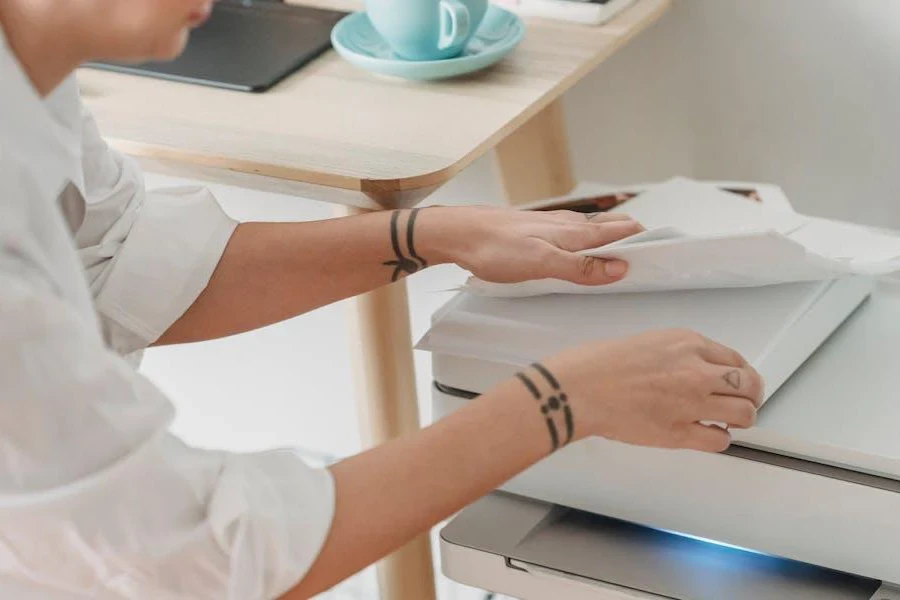 Woman preparing papers to use a printer