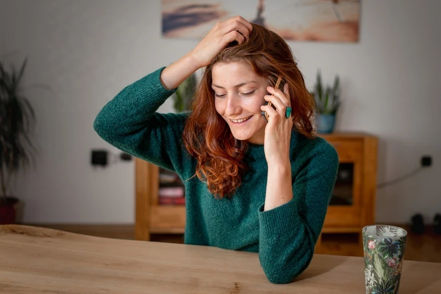 Woman sits, making a phone call