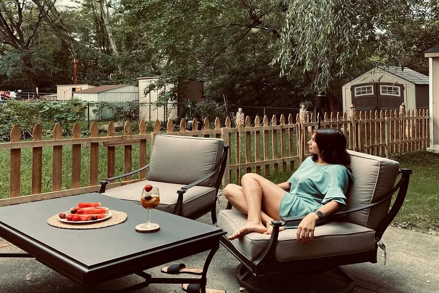 Woman sitting on patio lounge chair