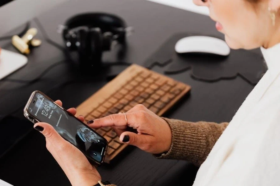 Woman using her smartphone in her workspace