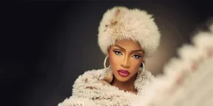 Woman wearing a white faux fur dome hat and coat