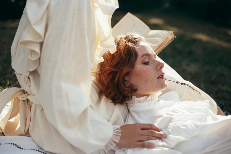 Women in Old-Fashioned Clothing on Picnic Blanket in Park