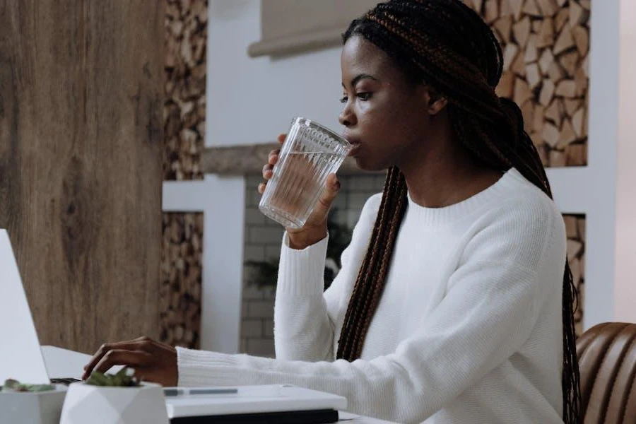 Writer holding a cup while crafting a blog