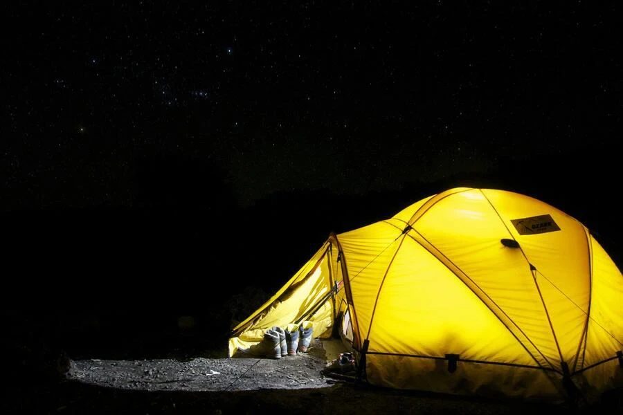 Yellow tent under starry night