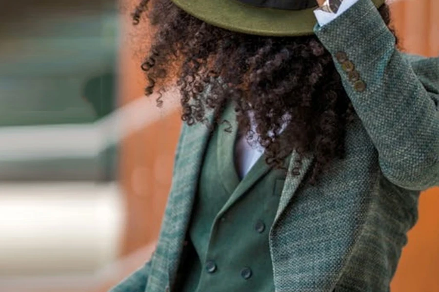 Young man in a green fedora, suit, and matching waistcoat