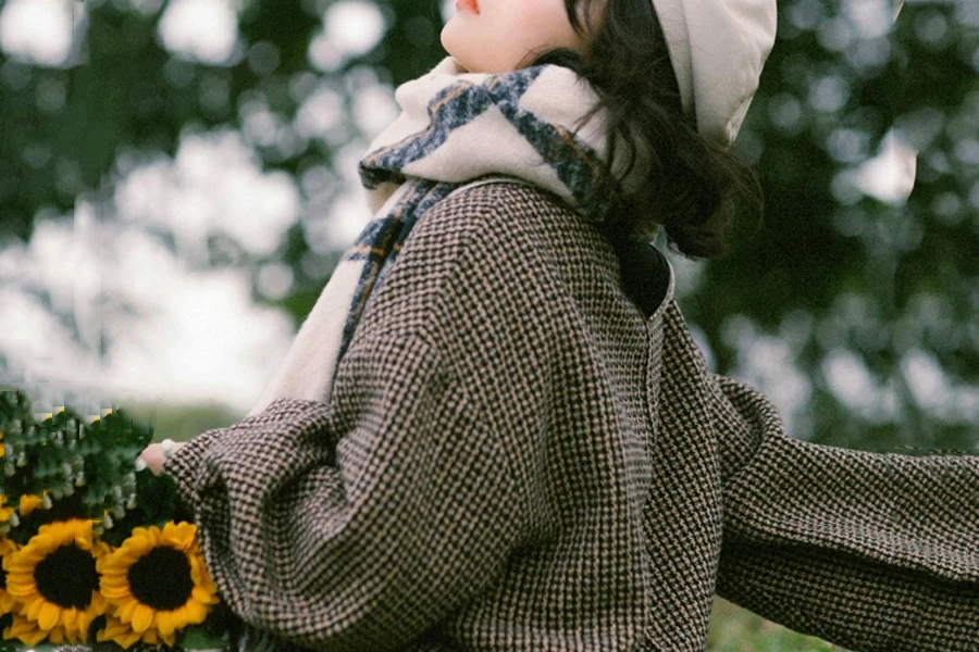 Young woman wearing a short, chunky tweed jacket