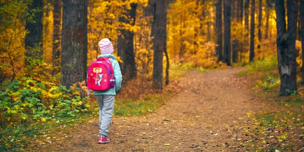 a kid walking in the woods