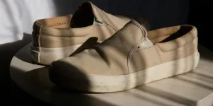 un par de zapatos de hombre de color beige sobre una mesa redonda