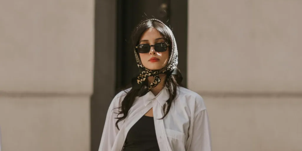 a woman wearing a headscarf with dark sunshades