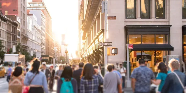 anonymous people walking down busy urban street