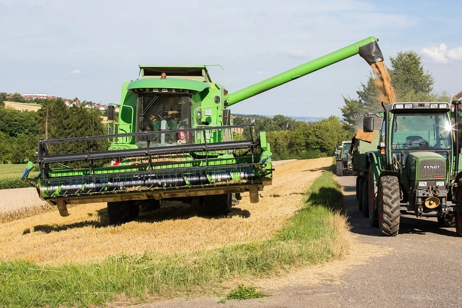 combine harvester with header adjusted to slope of the field