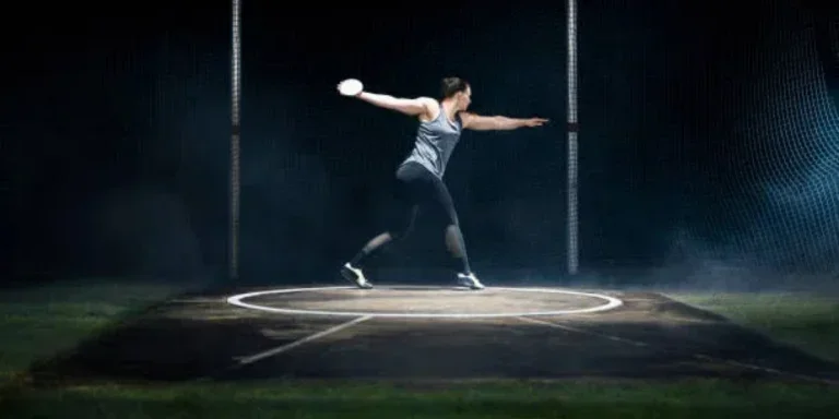 Female athlete inside a throwing circle with discus