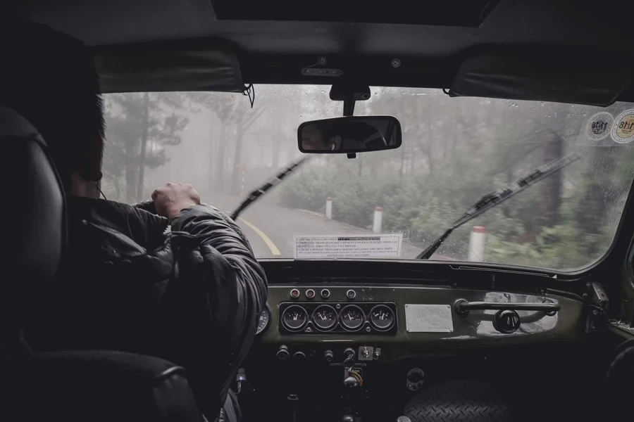 man driving car during rainy daytime