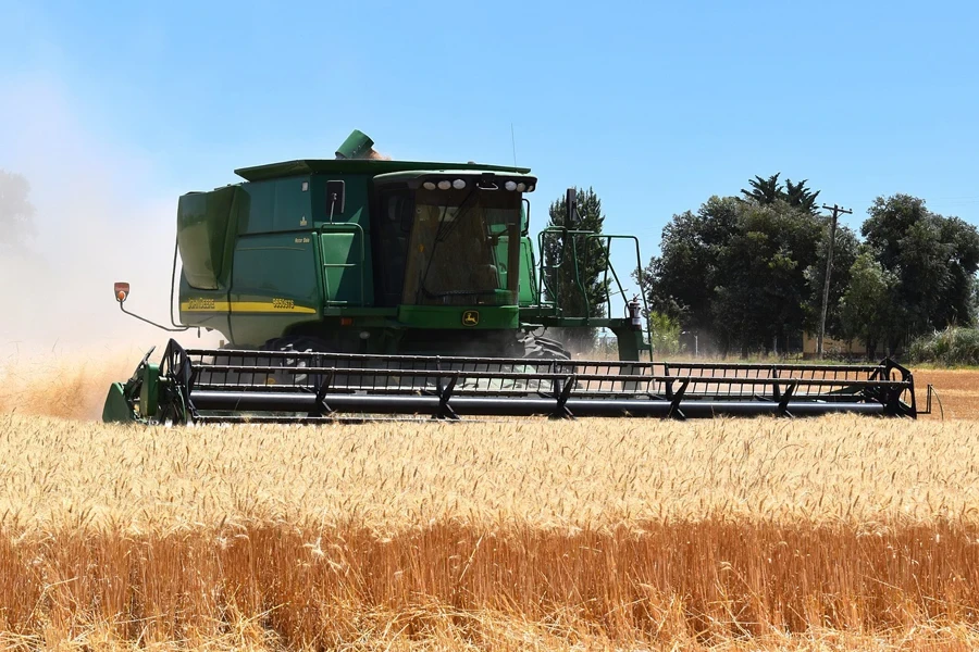 modern John Deere combine harvester in a wheat field