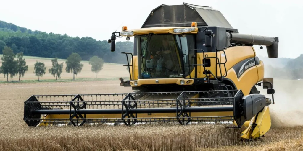 modern New Holland combine harvester with driver in cab