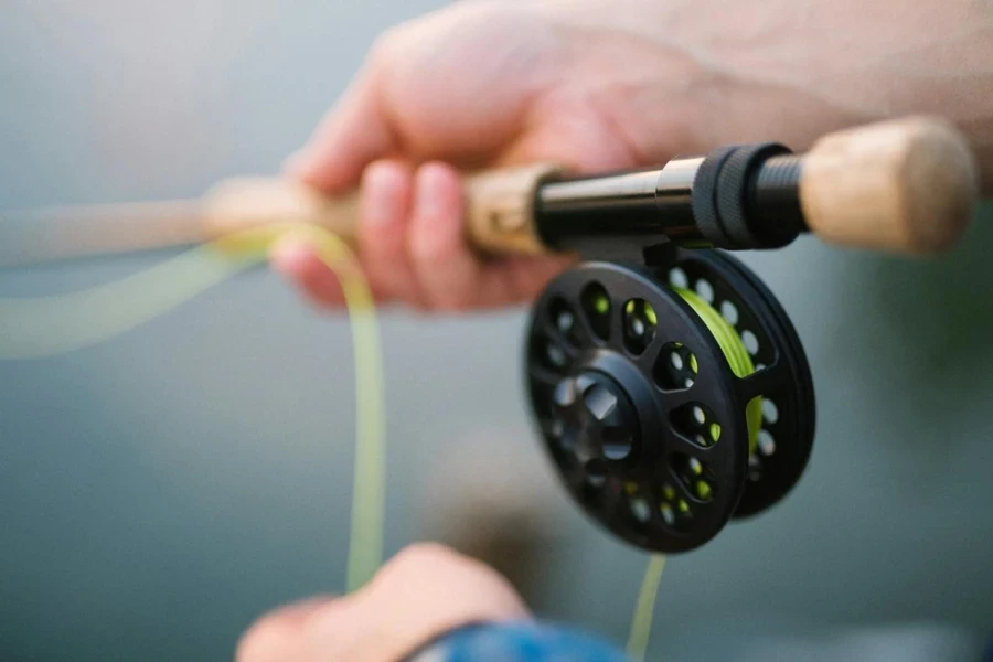 person holding black and brown fishing rod