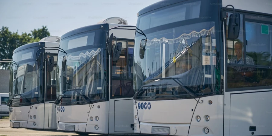 three big autobuses standing in the line while being ready to transport passengers