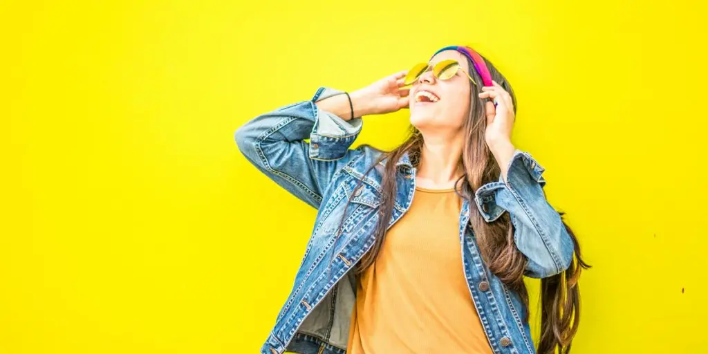 Women standing against a yellow background