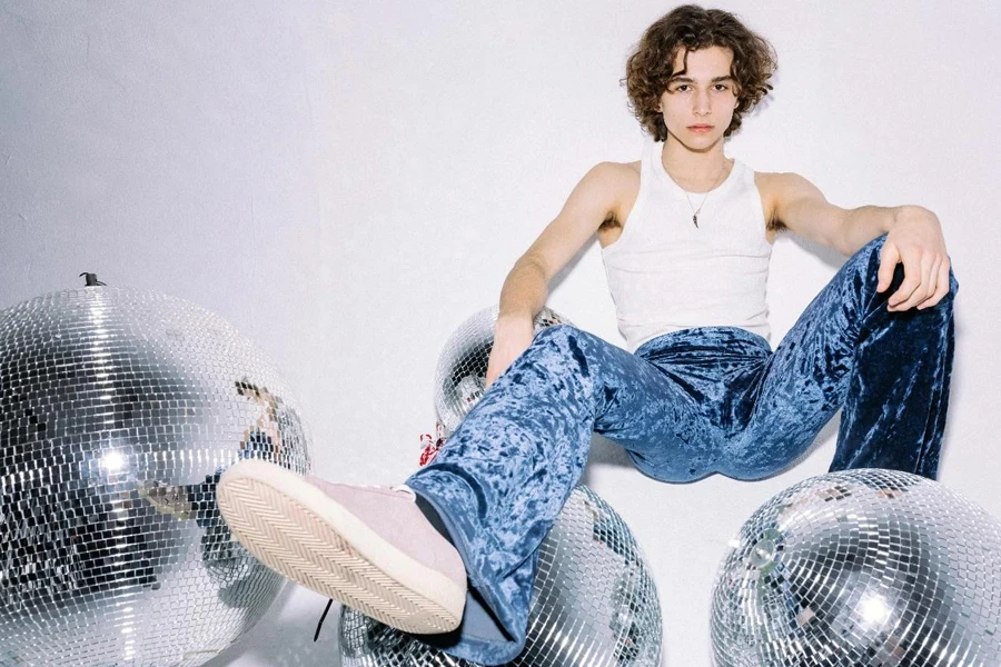 A Man Sitting on the Floor Beside Disco Balls