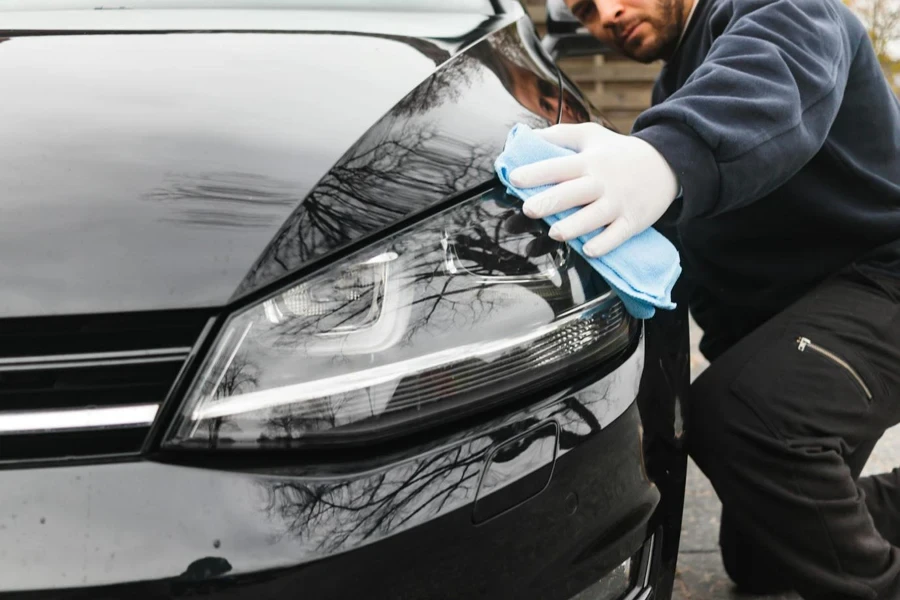 A Man Wiping a Car