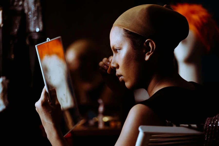 A Woman Applying Powder on Face