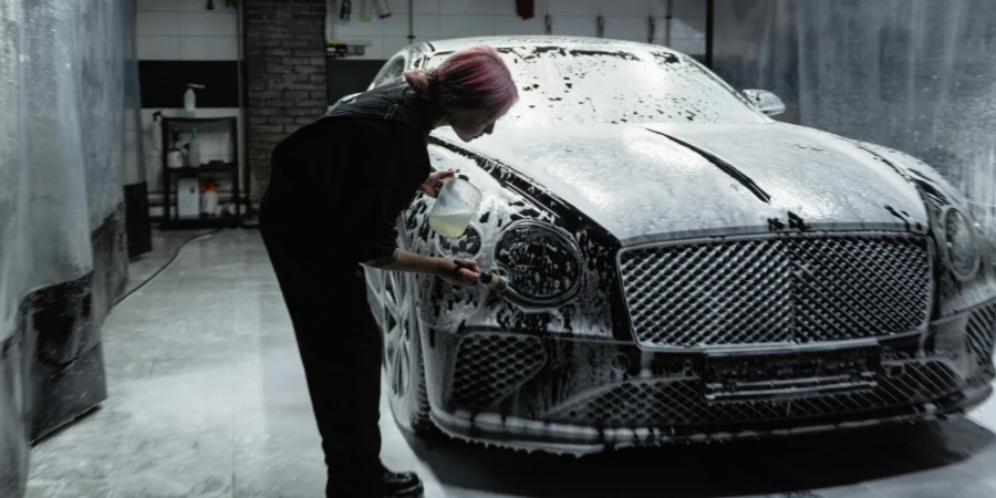 A Woman Washing a Luxury Car