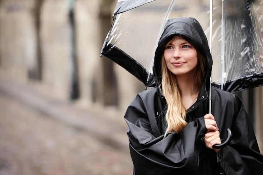 A Woman Wearing a Long Hooded Rain Jacket