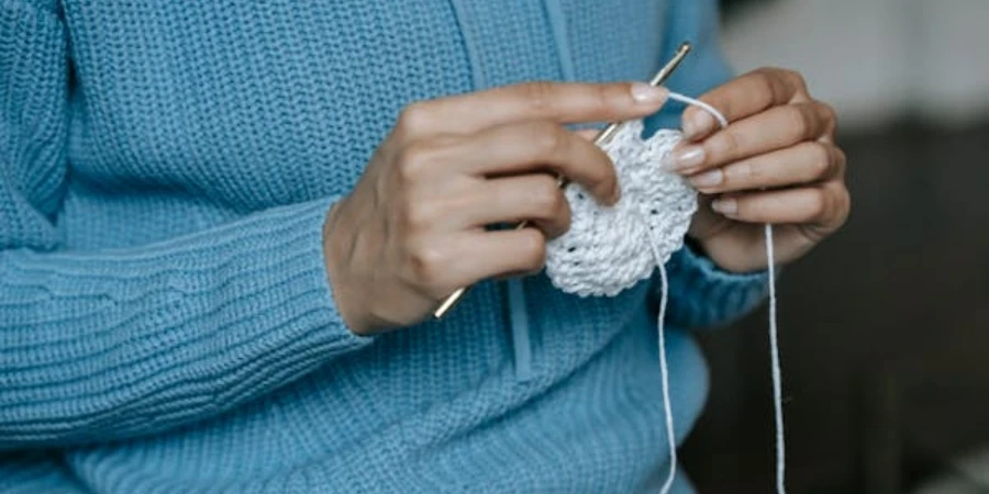 A Woman in a Sweater Is Knitting