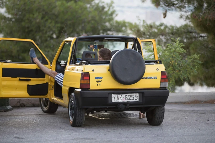 A Yellow Car Parked in a Parking Spot