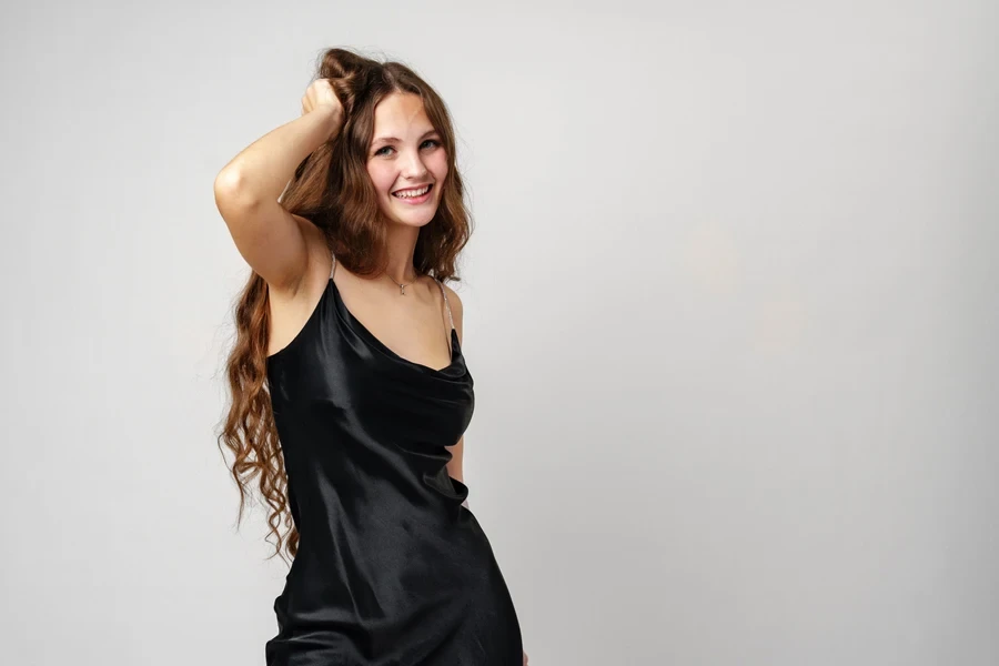 A beautiful woman dancing in a black slip dress