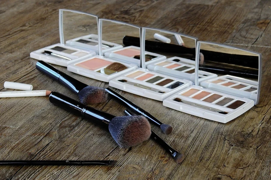 A few used makeup brushes kept on a wooden surface