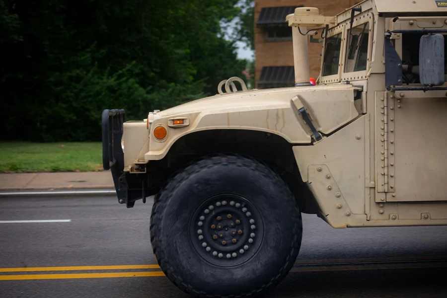 A large military vehicle is parked on the side of the road