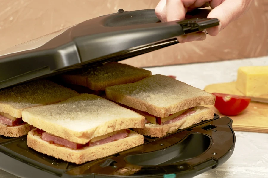 A man making sandwiches in a sandwich make