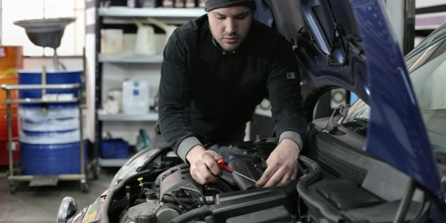 A man servicing a vehicle