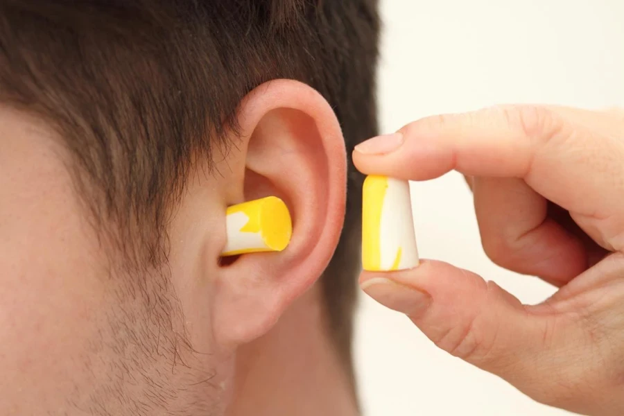 A man wearing earplugs