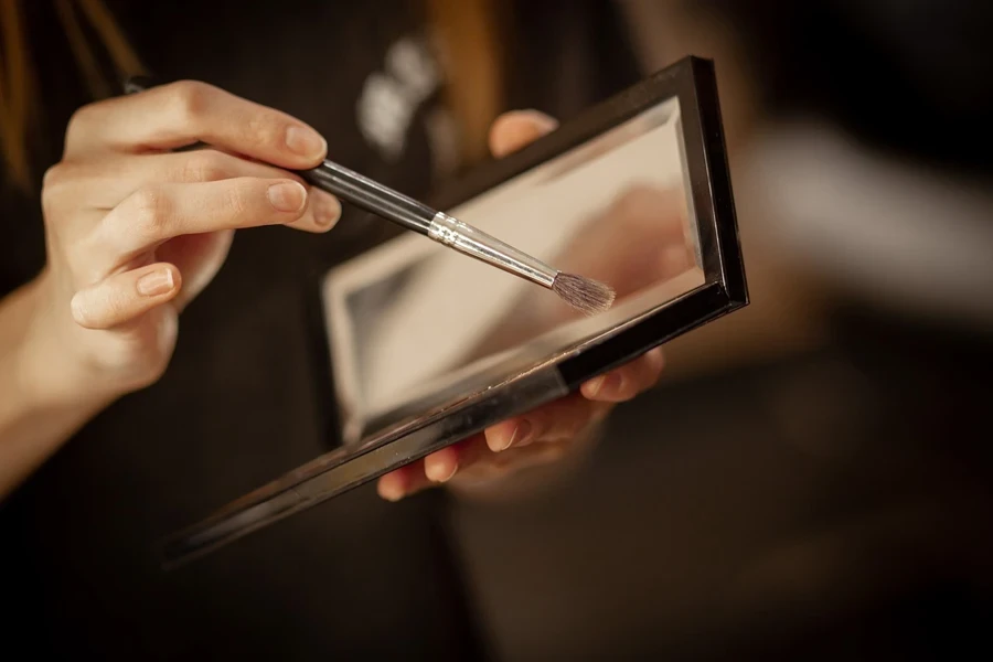 A person using a makeup brush