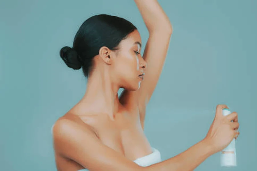 A pretty lady applying deodorant on her armpits