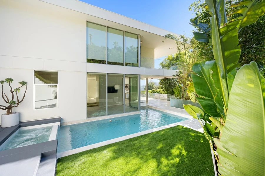 A rectangular plunge pool beside a luxurious villa