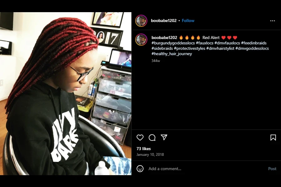 A screenshot of a woman after making burgundy goddess locs